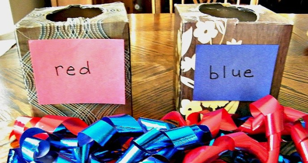Two kleenex boxes and ribbon become a color sorting activity for toddlers that takes minutes to make.