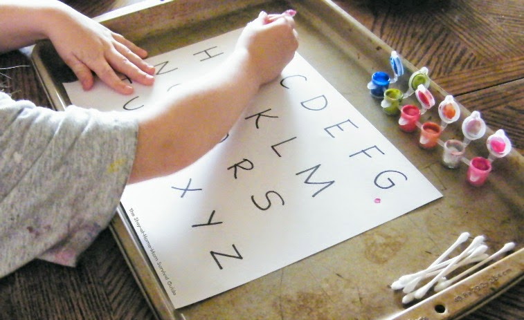 painting the letters with cotton swabs learning activity for teaching the alphabet to the creative child at The Stay-at-Home-Mom Survival Guide