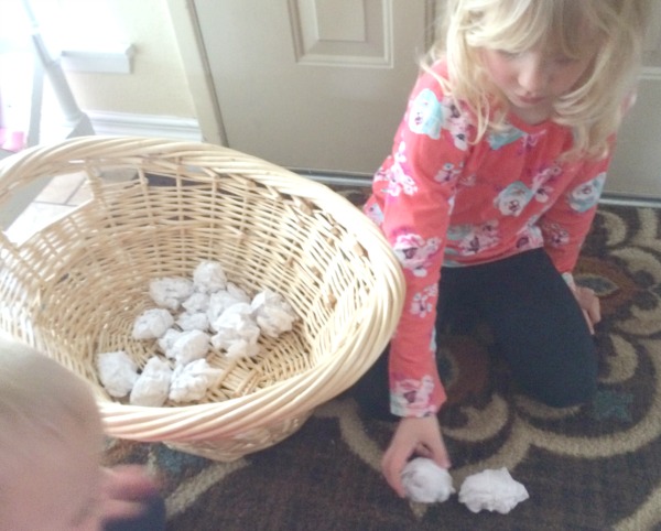 Too cold to play in the snow outside or don't have any snow where you live? Bring the snowball toss indoors for some gross motor fun for babies, toddlers, preschoolers and school age kids. This is so easy to set up with only two supplies. Great for indoor winter fun!