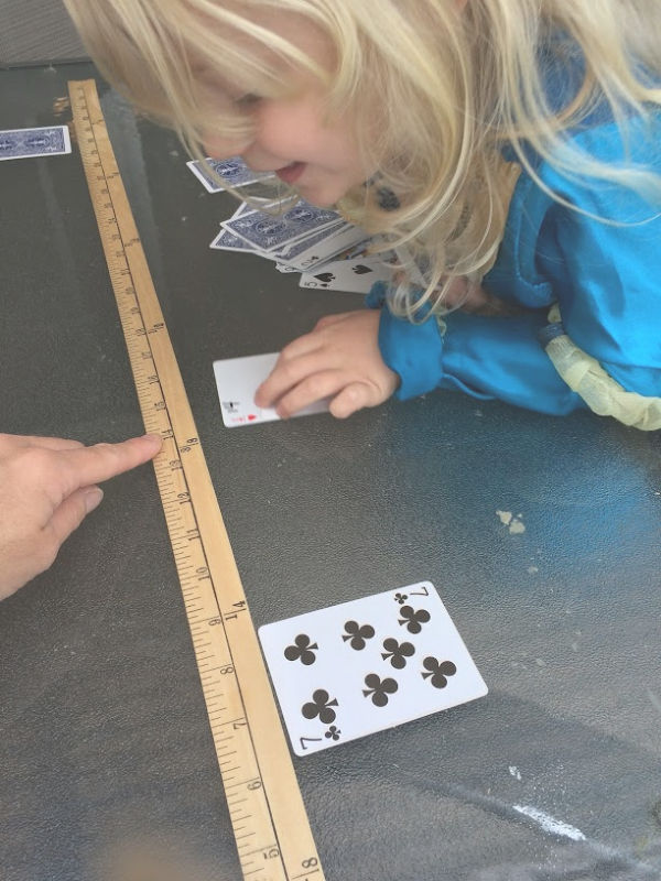 Learning greater than less than with playing cards builds number sense and math skills with a hands-on activity for kindergarten and early elementary age kids.