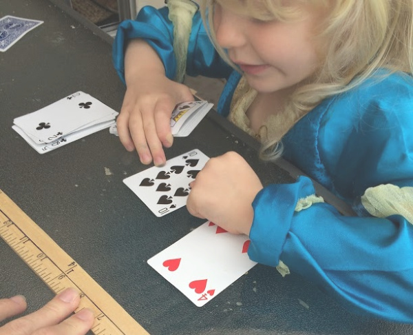 Learning greater than less than with playing cards builds number sense and math skills with a hands-on activity for kindergarten and early elementary age kids.