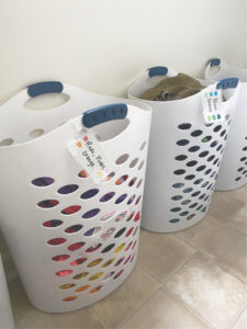 Laundry tips to save time: labeled hampers so kids can sort their own laundry.