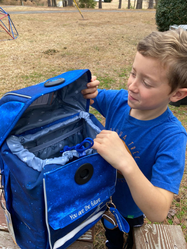 Kids can carry their own water and snacks starting about preschool age. This GMT Kids ergonomic backpack (sponsored) is a great one for distributing weight evenly for kids.