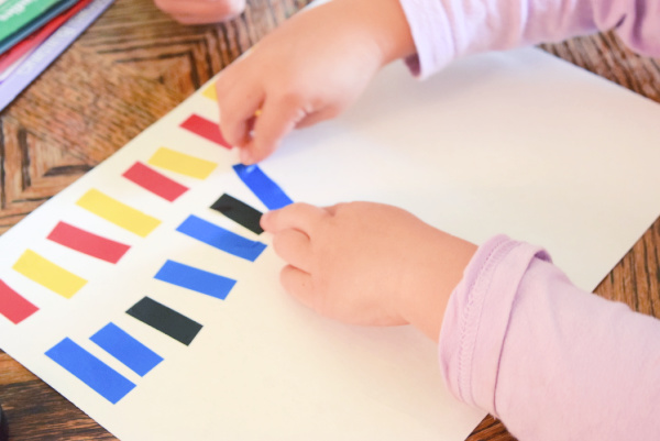 Preschoolers can learn about patterns with inexpensive materials like colored electrical tape. It is a great activity idea for preschool at home.