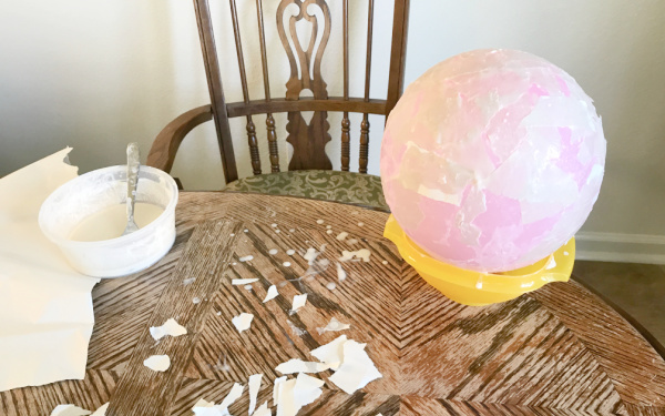 Step one for making a DIY globe model for kids is to set up the supplies and work area. 