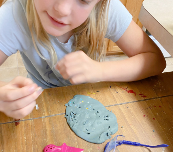 Adding perler beads to playdough and then digging them out helps kids understand how mining minerals in rock occurs in this hands-on geology activity. 