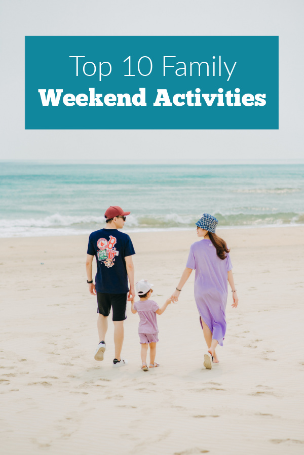 Family walking on the beach in the top 10 family weekend activities list.