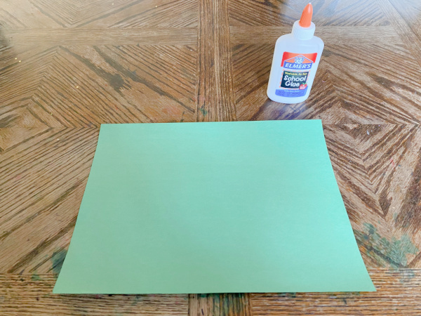 Glue bottle and construction paper ready for child to create.
