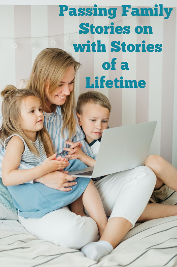 A mother sits with her two children watching their stories of a lifetime on a laptop.