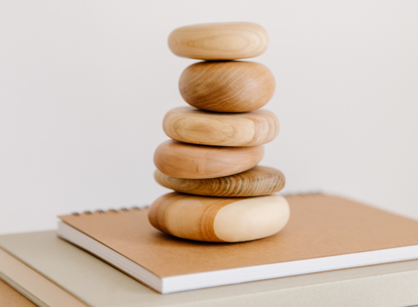 Rock structure balanced in a tower on top of a book.