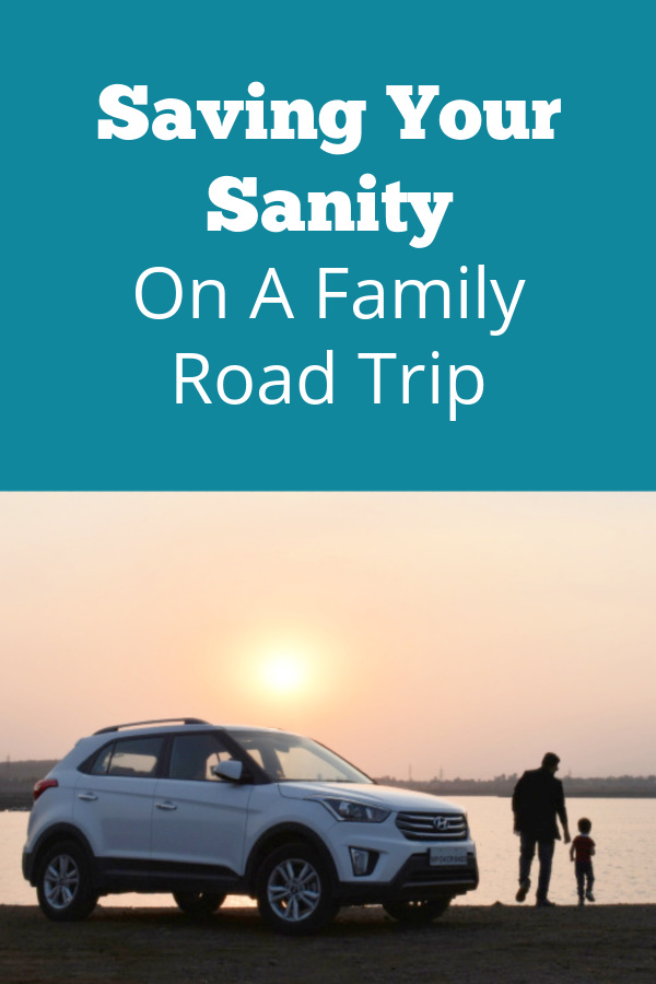 Car parked with parent and child watching the sunset text reads saving your sanity on a family road trip.