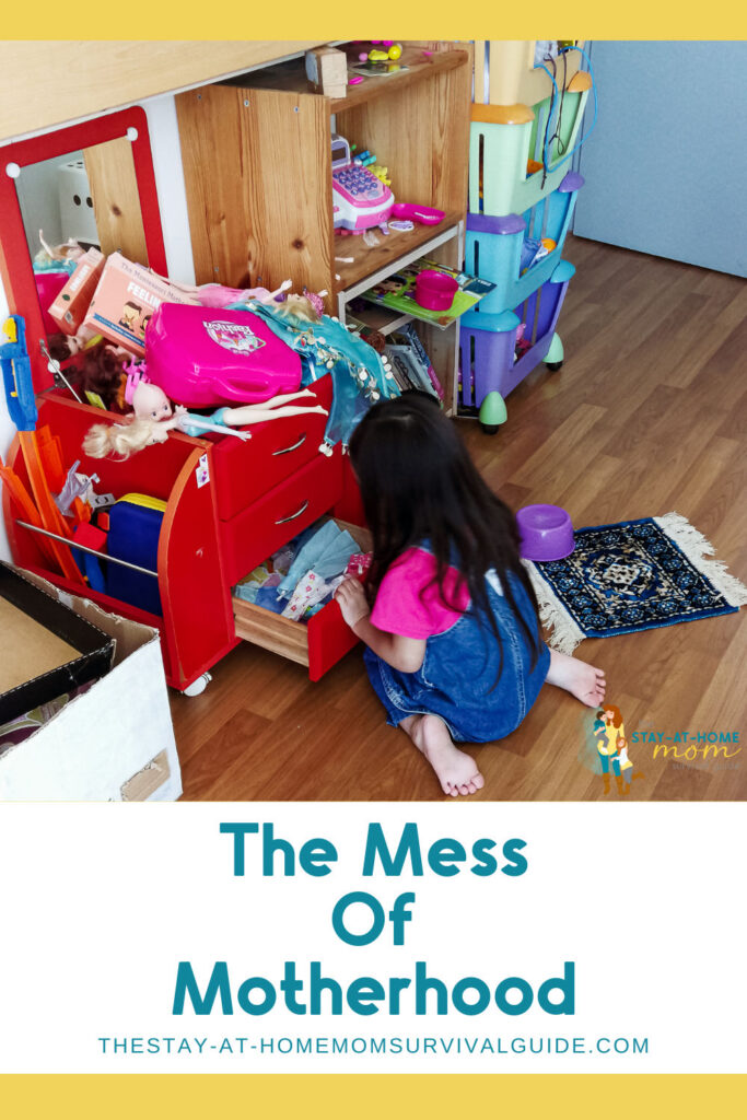 Child kneeling in a messy playroom. Text reads The Mess of Motherhood.